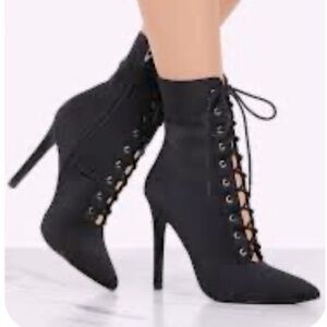 Olivia Ferguson black pointed toe corset, lace up booties.